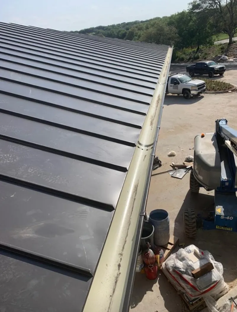 Standing seam panel and gutter detail on a metal roofing jobsite in South Hill